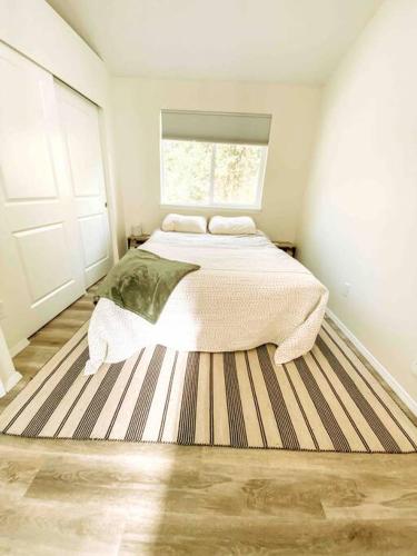 a bedroom with a large bed and a window at Si View in North Bend