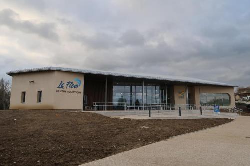 a building with a sign on the side of it at Le Sophora in Chéu