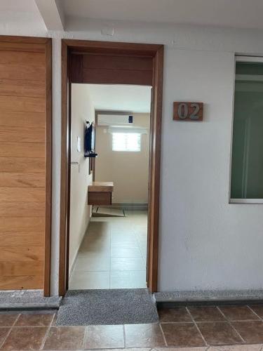 a hallway with a door open to a room at Hotel Santo Domingo Express in Villahermosa