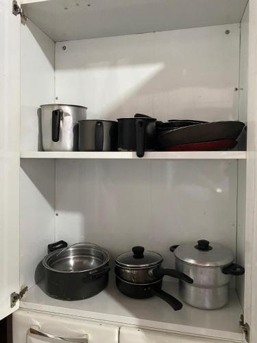 a kitchen with pots and pans on a shelf at Hostel Roraima in Boa Vista