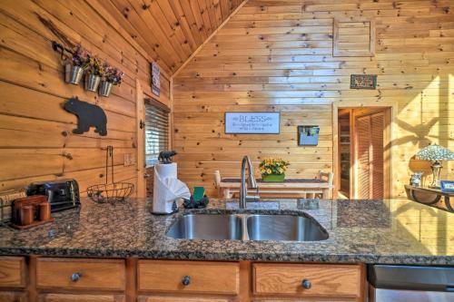 a kitchen with a sink in a cabin at Inviting Sevierville Cabin with Deck and Hot Tub! in Sevierville