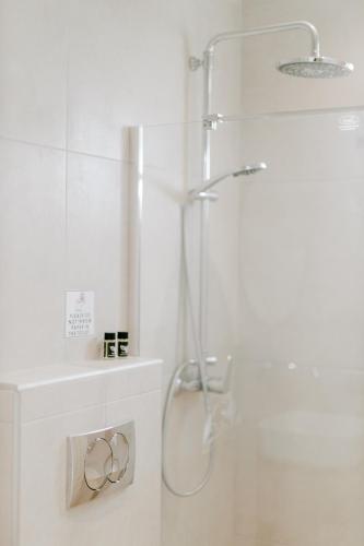 a white bathroom with a shower and a sink at Aelia Prime Experience 3 in Kos
