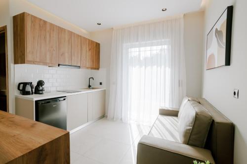 a kitchen with a couch and a table in a room at Aelia Prime Experience 3 in Kos Town