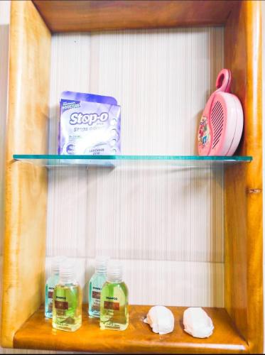 a wooden shelf with soap and other items on it at Hotel Nilketha Yala Tissamaharama in Tissamaharama
