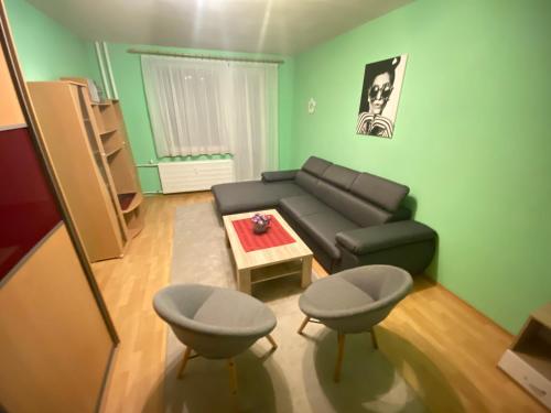 a living room with a couch and a table at Apartmán Jasmin Levice in Levice
