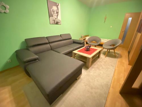 a living room with a couch and a table at Apartmán Jasmin Levice in Levice