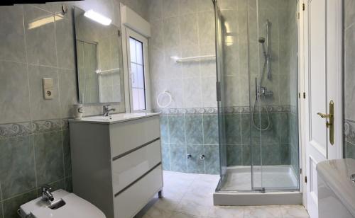 a bathroom with a shower and a toilet and a sink at Ribadesella playa 3 in Ribadesella