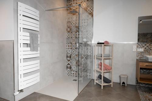 a shower with a glass door in a bathroom at CLB Ferienwohnung in Reutte