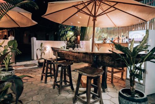 a bar with a table and chairs and an umbrella at Kahawa house in Zanzibar City