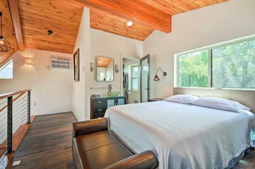 a bedroom with a bed and a large window at Beach Escape Scenic Osoyoos Lake Chalet! in Oroville