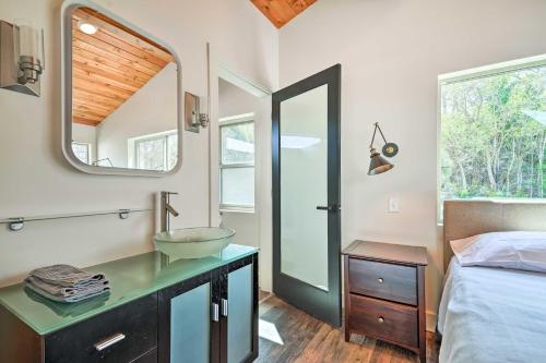 a bedroom with a sink and a mirror at Beach Escape Scenic Osoyoos Lake Chalet! in Oroville
