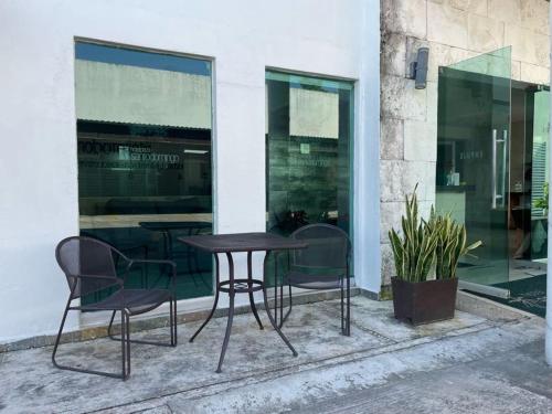 a table and chairs in front of a building at Hotel Santo Domingo Express in Villahermosa