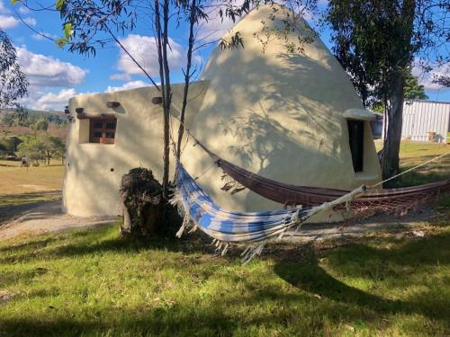 a house that is sitting in the grass at Valle de Domos - Minas in Minas