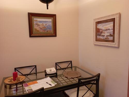 a dining room with a glass table and chairs at EL BALCÖN DE AVILÉS, acogedor con garaje en centro histórico, in Avilés