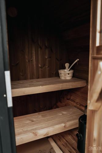 a wooden shelf in a sauna with a basket on it at Pause Cachée in Walhain-Saint-Paul