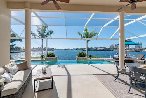 an indoor pool with a view of the water at Southern Exposure I Waterfront 5 Bed House I Wide Water Views of Landmark Bay in Marco Island