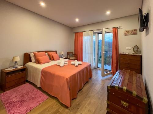 a bedroom with a bed and a large window at Casa de Campo Sonhos D'ouro in Ribeira