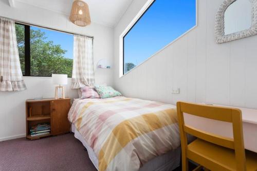 a bedroom with a bed and a window at Beach, Bikes and Bonfires in Opotiki