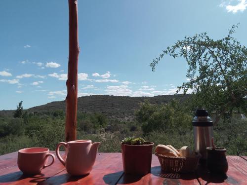 a table with cups and baskets on it with a view at La Inspiración - Casa Serrana in Tanti