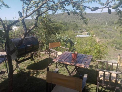 a table and chairs in the shade of a tree at La Inspiración - Casa Serrana in Tanti