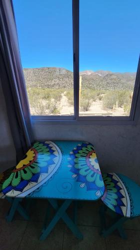 a room with a window with a table and a pillow at LA TORRE del TANO in Uspallata