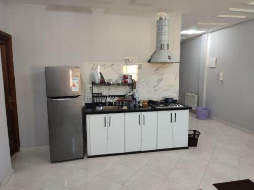 a kitchen with white cabinets and a refrigerator at Thé good stay4 midelt in Midelt