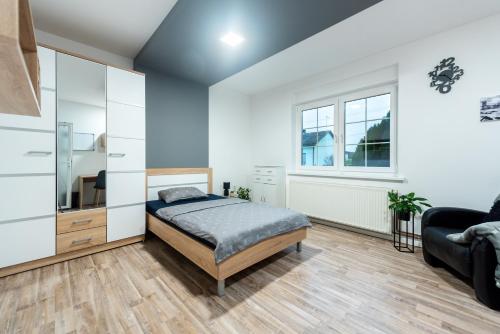 - une chambre avec un lit et un canapé dans l'établissement Apartmani Majetić, à Valpovo