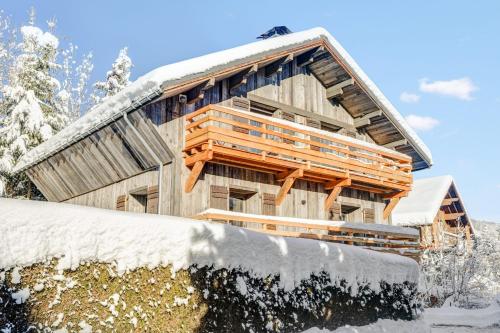 a log cabin in the snow with a pile of snow at Luxury flat 2 steps to the cable cars in Megève - Welkeys in Megève