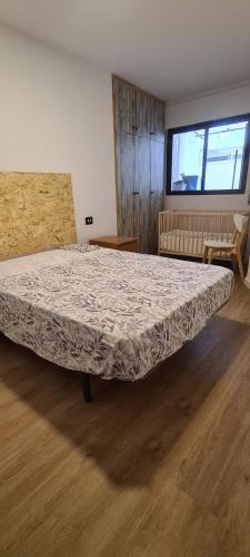 a bedroom with a large bed in a room at Lovely apparment in fornt of the port of Gandia in Los Mártires