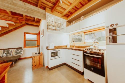 a kitchen with a sink and a stove top oven at Morada Guarda Explorer 01 in Guarda do Embaú