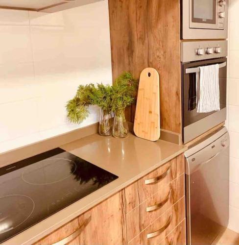 a kitchen with a counter with a stove and a microwave at Ses cases noves Llucmajor in Llucmajor