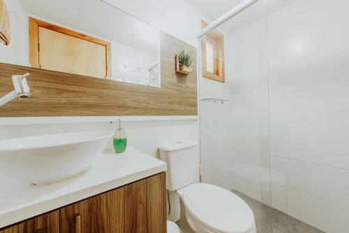 a bathroom with a white sink and a toilet at Morada Guarda Explorer 01 in Guarda do Embaú