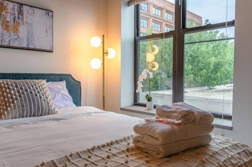 a bedroom with a bed with a large window at McCormick Place Spacious family heaven 3b/2b with optional parking that sleeps up to 8 in Chicago