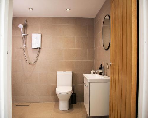 a bathroom with a toilet and a sink at Bird House - Sleep with the Owls! in Carlisle