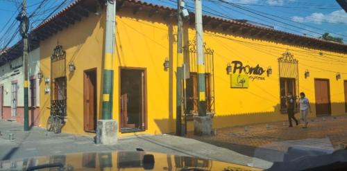 a yellow building on the side of a street at APARTAMENTOS CASCO HISTORICO COMAYAGUA in Comayagua