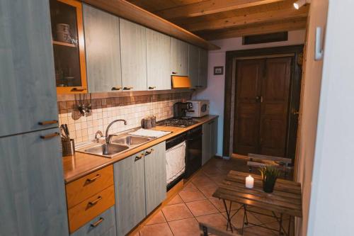a kitchen with a sink and a stove at LA DIMORA DEL PRINCIPE - Relaxing Private Terrace & City View in Polignano a Mare