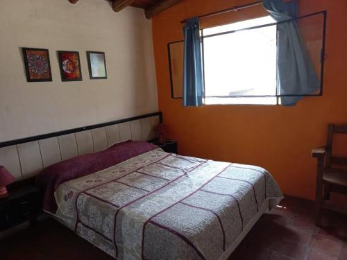 a small bedroom with a bed and a window at fatima cabaña 4personas in Villa de Las Rosas