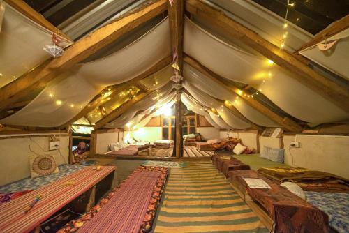 a large tent with many beds in it at Zevibes Cafe & Homestay in Kalgha