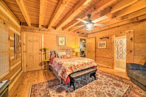 a bedroom with a bed and a ceiling fan at Quiet Cabin Retreat on 30 Acres Near Kentucky Lake in New Concord