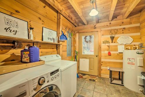 a kitchen with a washing machine and a refrigerator at Quiet Cabin Retreat on 30 Acres Near Kentucky Lake in New Concord