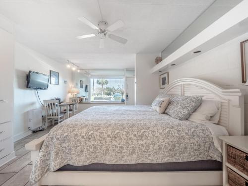a bedroom with a large bed and a table at The Waterway Pet Friendly by Carolina Retreats in Wrightsville Beach
