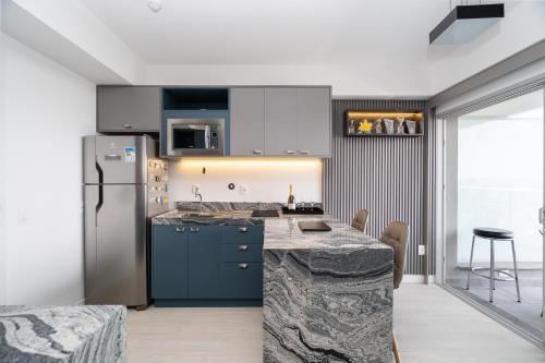 a kitchen with a counter top and a refrigerator at River One 2303 - Luxury Studio in São Paulo