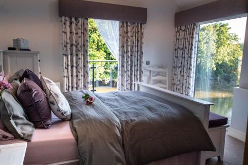 a bedroom with a large bed with a large window at The Quay Pottery in Kent