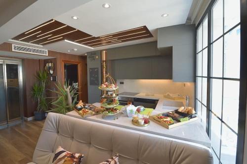 a kitchen with a couch and a counter with food on it at Dar Khouadja maison d’hôtes in Mahdia