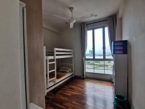 a bedroom with two bunk beds and a large window at Ocean Palms in Melaka