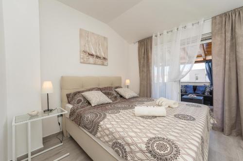 a bedroom with a large bed and a window at Villa Lana in Privlaka