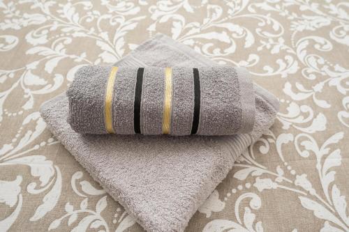 a towel sitting on top of a bed at Villa Lana in Privlaka