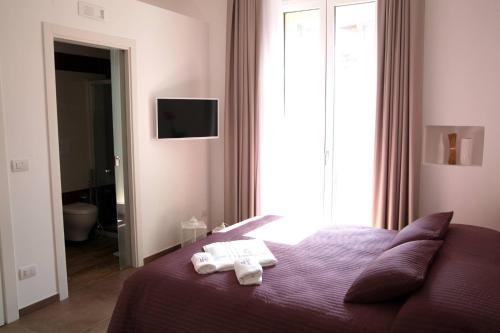 a bedroom with a bed with two towels on it at Essence in Barletta