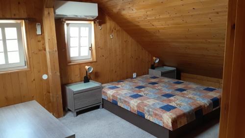 a bedroom with a bed in a wooden cabin at Chalupa Naty Zdíkov in Zdíkov