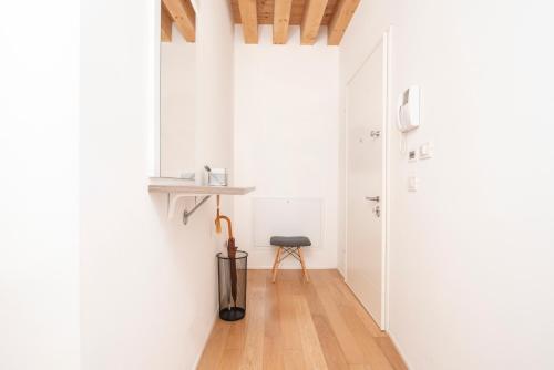 a hallway with white walls and a wooden floor at Loft 96 in Venice